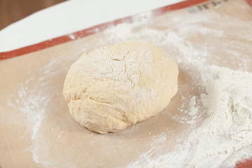 Ball of pizza dough on background
