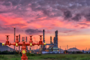 Fire hydrants and oil refinery plant blur background.