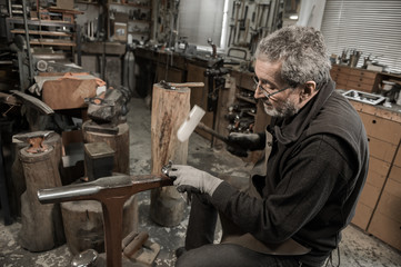 Master goldsmith working with silver-Shaping of the object by ha