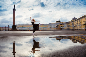 The young woman, the ballerina dances on the square