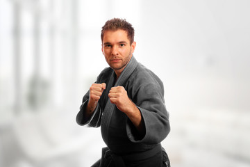 Karate man in a kimono and in a combat stance ready for a fight