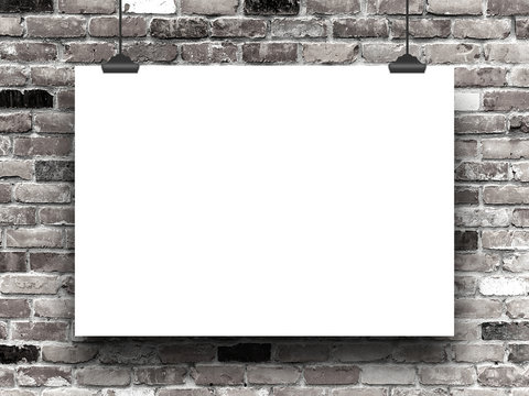Close-up of one horizontal hanged paper sheet with clips on black and white brick wall background