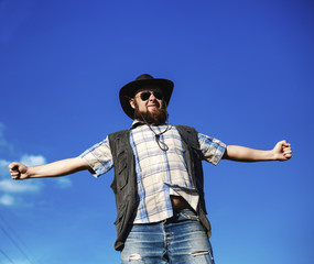 Naklejka premium Farmer in the hat and sunglasses with the pitchfork outdoor