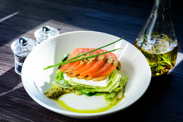 classic Caprese salad with tomatoes, cheese, herbs and sauce