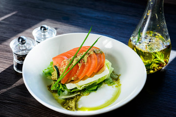 classic Caprese salad with tomatoes, cheese, herbs and sauce