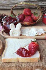Fresh strawberries red and jam with bread.