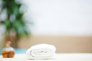 Fototapeta na wymiar Folded towel and massage essential oil