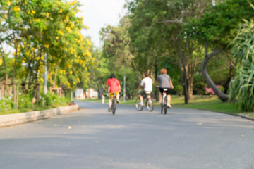 three people on bicycle blur background
