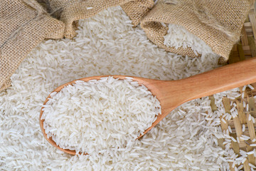 Top view  jasmine's rice with wooden spoon and woven bamboo