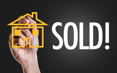 Hand writing the text: Sold
