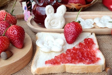 Fresh strawberries red and jam with bread.