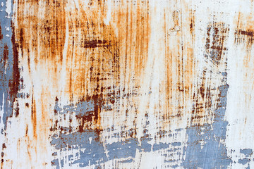 A background of peeling paint and rusty old metal