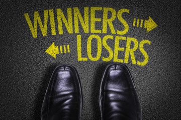 Top View of Business Shoes on the floor with the text: Winners - Losers