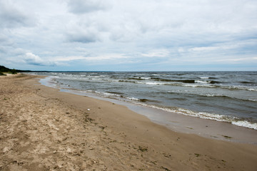 Fototapeta na wymiar Rocky beach with clouds
