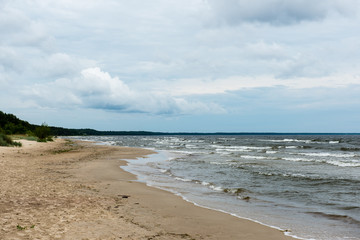 Fototapeta na wymiar Rocky beach with clouds