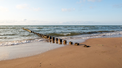 Breakwater of one row of wooden poles at the Sea coast