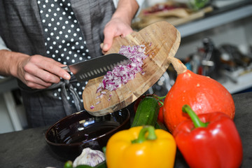 Hand of a handsome young man standing at his food stall with  in
