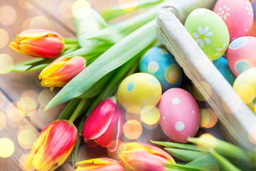 close up of colored easter eggs and flowers