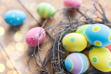 Fototapeta na wymiar close up of colored easter eggs in nest on wood