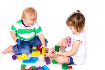 Happy kids playing with building blocks isolated on white