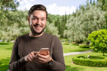 Handsome young man using his smartphone