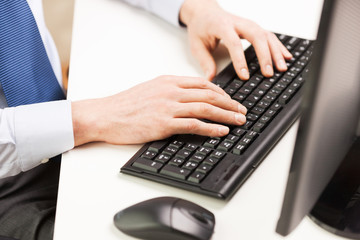 close up of businessman hands typing on keyboard