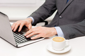 close up of businessman with coffee and laptop