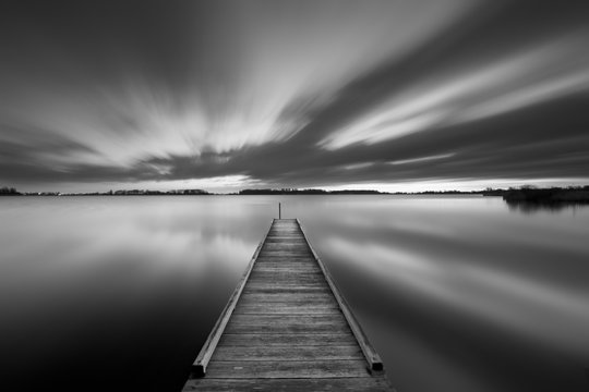 Jetty on a lake in black and white