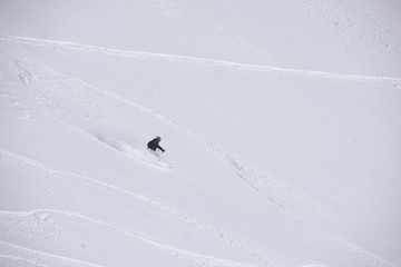 freeride skier skiing in deep powder snow