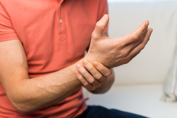 close up of man with  pain in hand at home