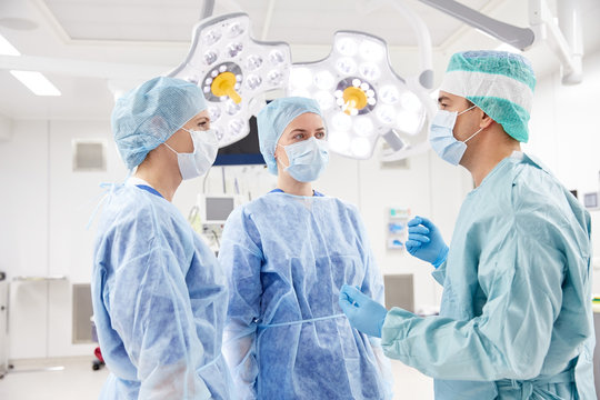 group of surgeons in operating room at hospital