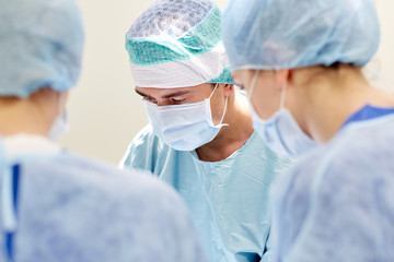 group of surgeons in operating room at hospital