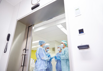 group of surgeons in operating room at hospital