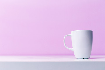 Cups on lilac background