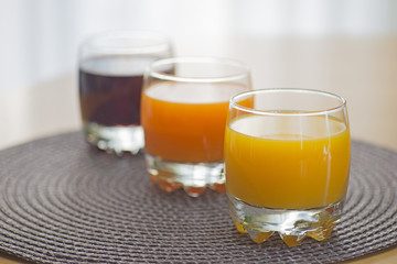 Multi fruit citrus juice from oranges, lemons, bananas, grapes in a glass