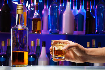Men hand with drink and whiskey bottle 