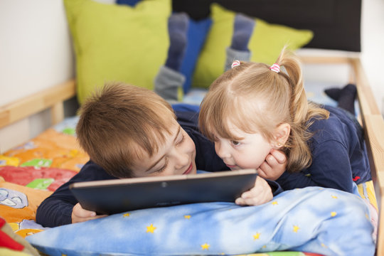 Brothers reading in bed