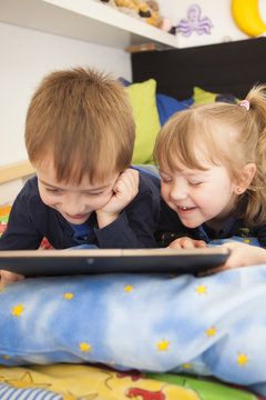 Brothers reading in bed