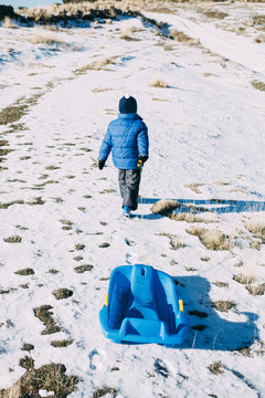 Child in the snow with a sledge