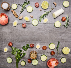 Ingredients for cooking vegetarian food cherry tomatoes, tomatoes, rosemary, onion, lettuce, parsley, cucumber, tiled frame on wooden rustic background top view close up