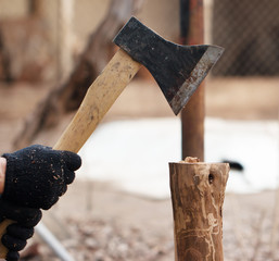 the man's hand chopping wood