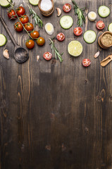 Ingredients for cooking vegetarian food wooden spoons, cherry tomatoes, dill, parsley, pepper border ,place for text  on wooden rustic background top view close up
