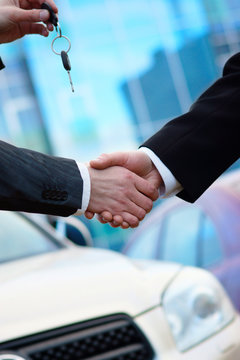 Handshake in auto show or salon