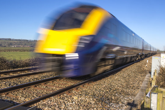 Fototapeta Close up of train speeding through English countryside with motion blur