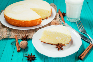 
pastries, desserts , curd pudding with milk,cottage cheese casserole , cinnamon and nuts on a wooden background