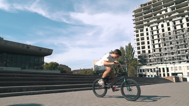 	BMX rider doing tricks in the city, slow motion