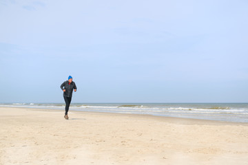 Senior man running at beach