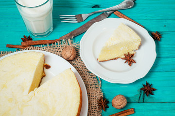 
pastries, desserts , curd pudding with milk,cottage cheese casserole , cinnamon and nuts on a wooden background
