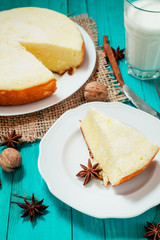 
pastries, desserts , curd pudding with milk,cottage cheese casserole , cinnamon and nuts on a wooden background