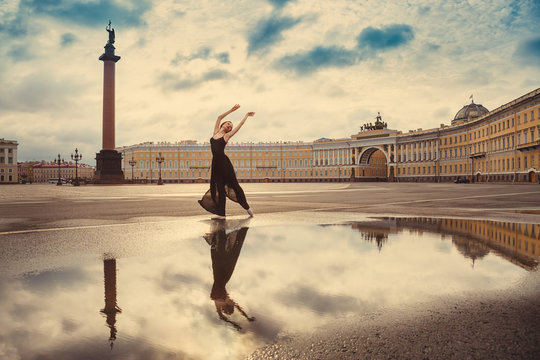 The young woman, the ballerina dances on the square